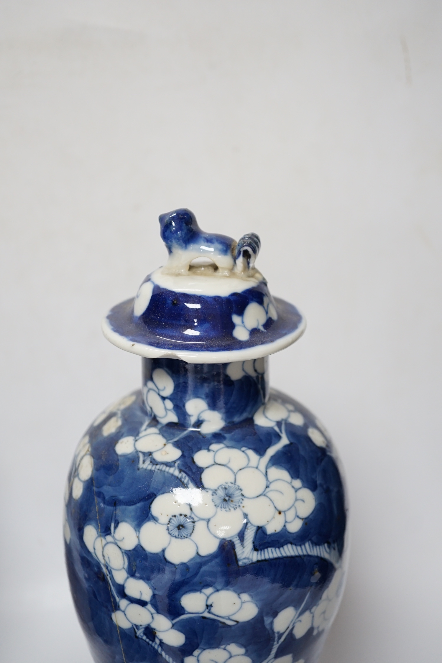 Five early 20th century Chinese blue and white prunus vases and covers, tallest 31cm